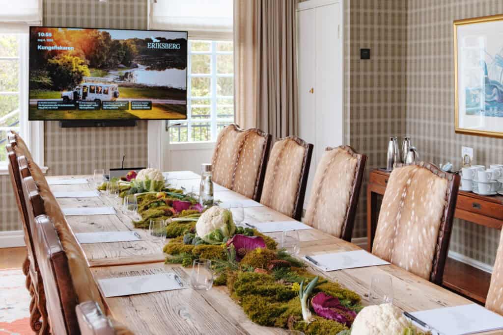 Conference room at Eriksberg with long tables and views of nature.